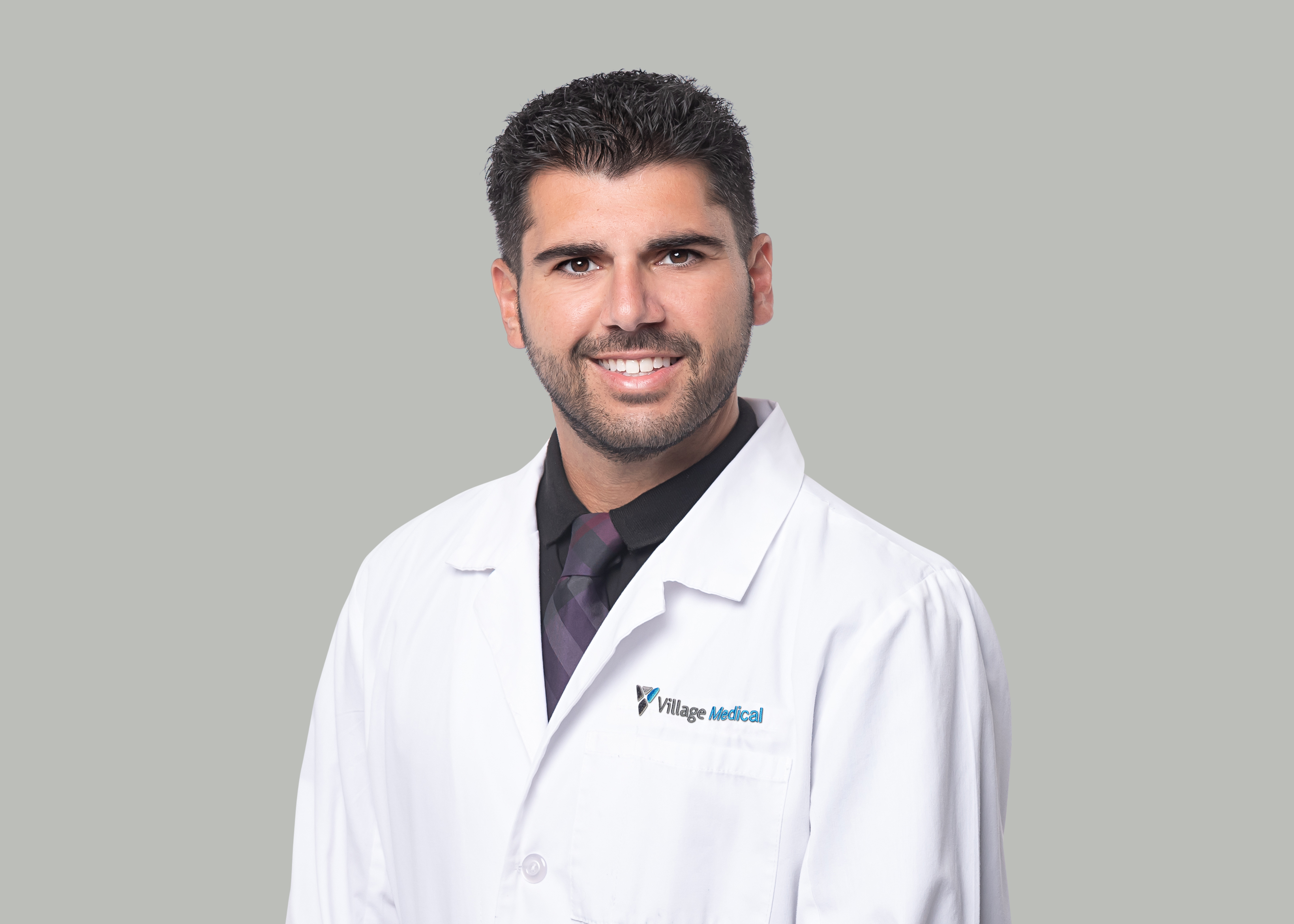Professional headshot of Justin Noroyan, DO