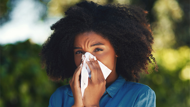 A woman struggling with a longer allergy season
