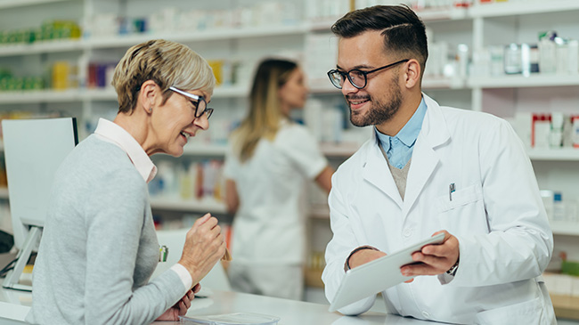 A Village Medical pharmacist explaining medication safety to a patient