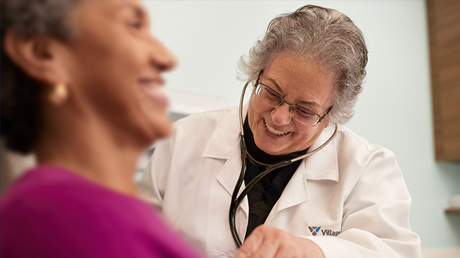 Village Medical primary care provider helping a woman with menopause management