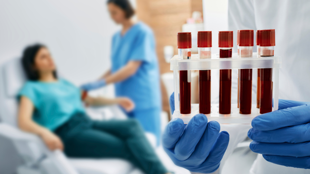 Village Medical doctor holding vials of blood from different types of blood tests in front of a patient having her blood drawn