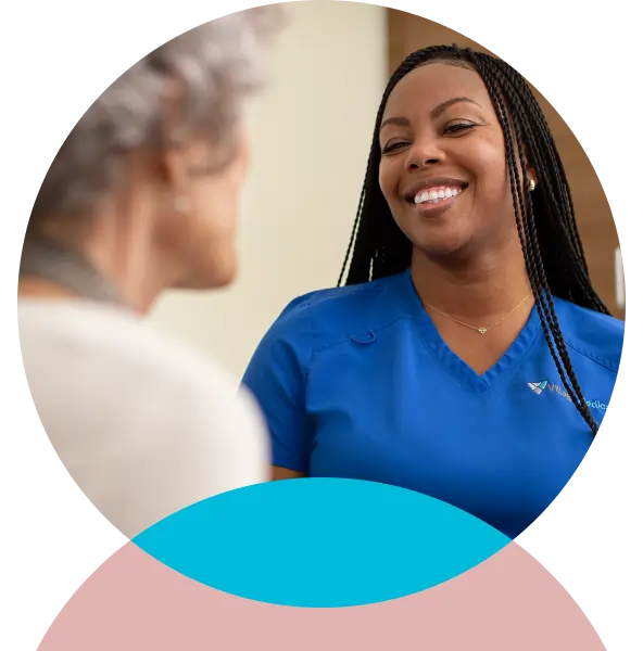 Smiling clinician with a patient